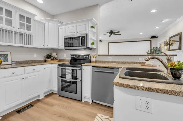 a kitchen with a stove a sink and a microwave