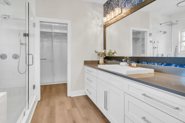 a spacious bathroom with a double vanity sink and a mirror