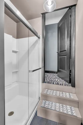 a bathroom with double vanity sink a two mirror a window and a bathtub