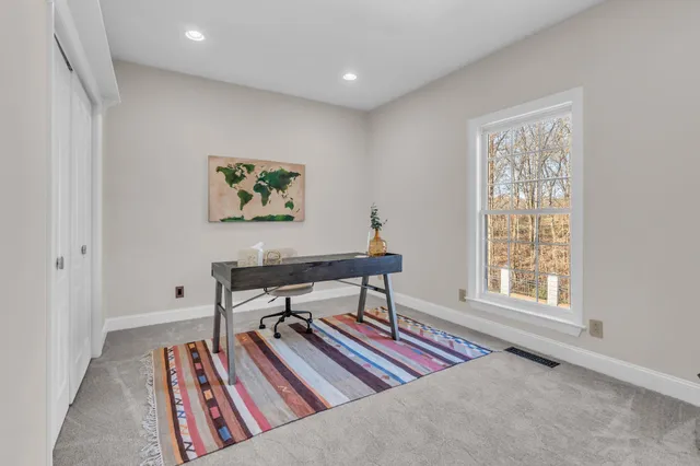 a room with pool table and windows