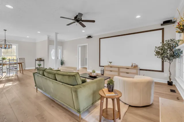 a dining room with furniture a chandelier and wooden floor