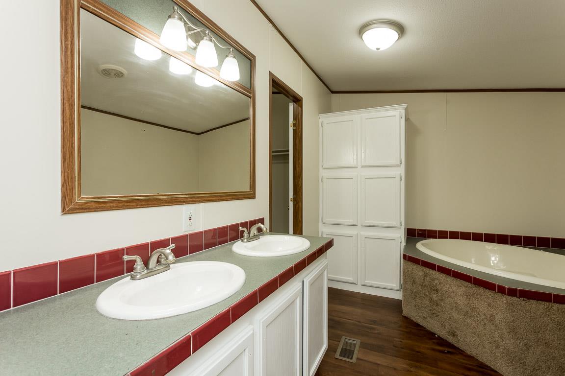 744 Tracy Road Watertown, TN 37184 - Photo 11 of 18 a bathroom with a sink and a mirror
