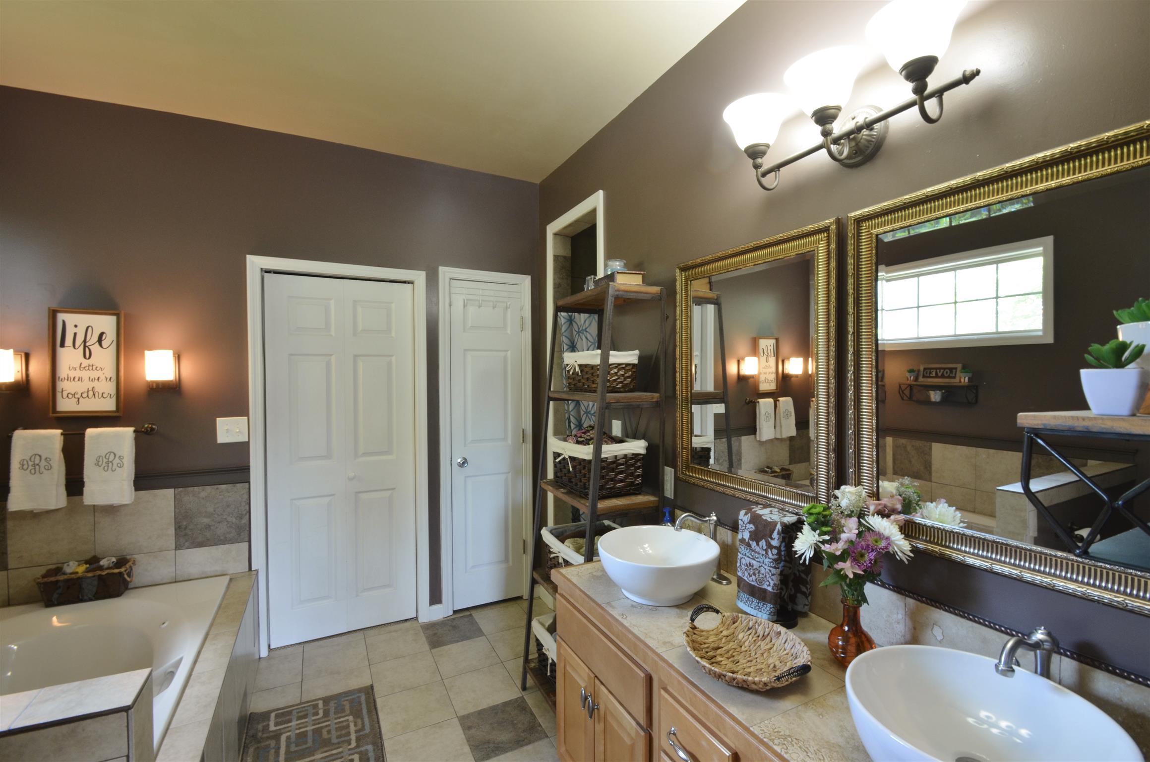 391 Vesta Road Lebanon, TN 37090 - Photo 12 of 24 a bathroom with a granite countertop sink a toilet a mirror and shower