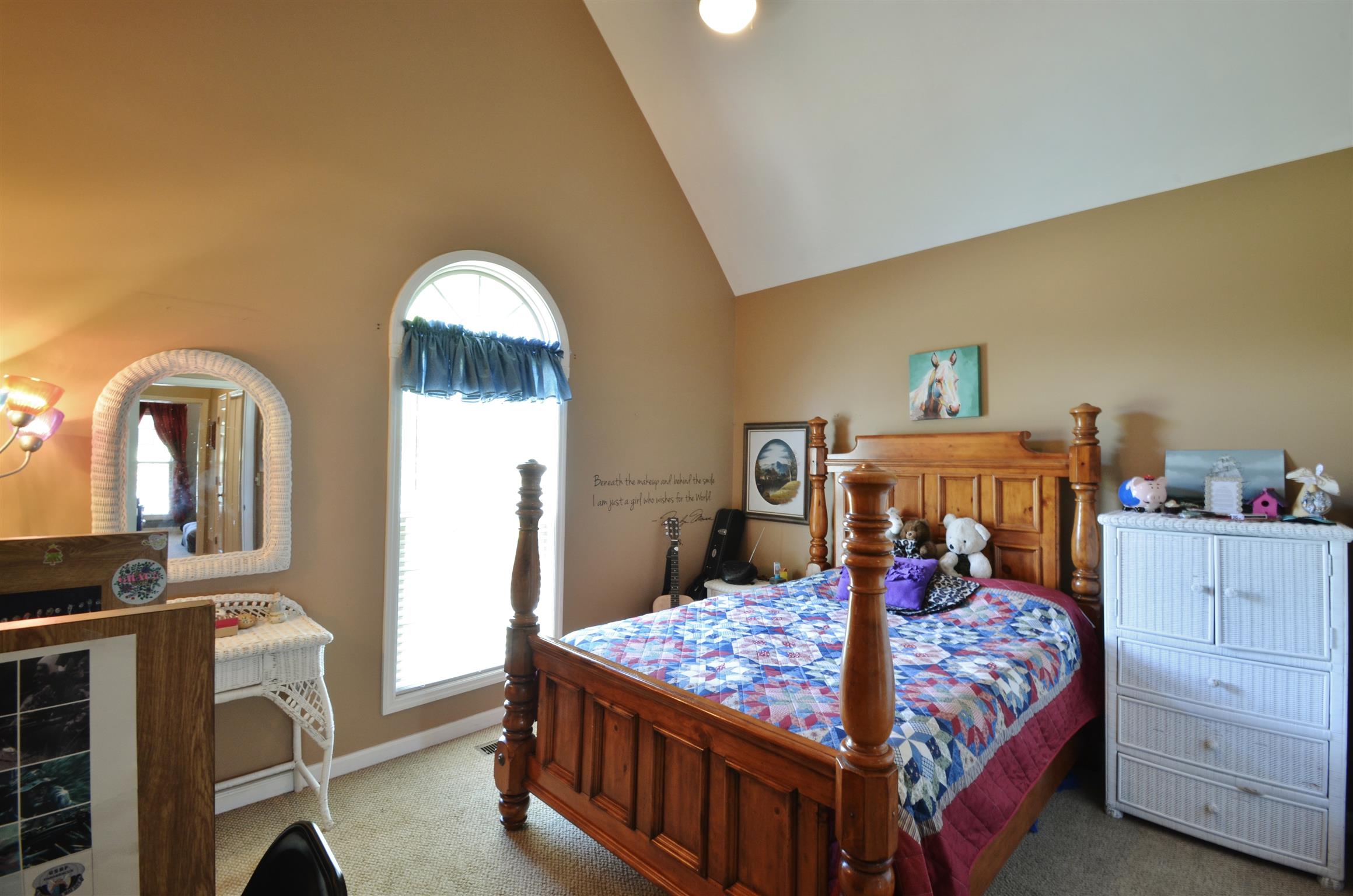 391 Vesta Road Lebanon, TN 37090 - Photo 16 of 24 a bedroom with a bed a mirror and dresser