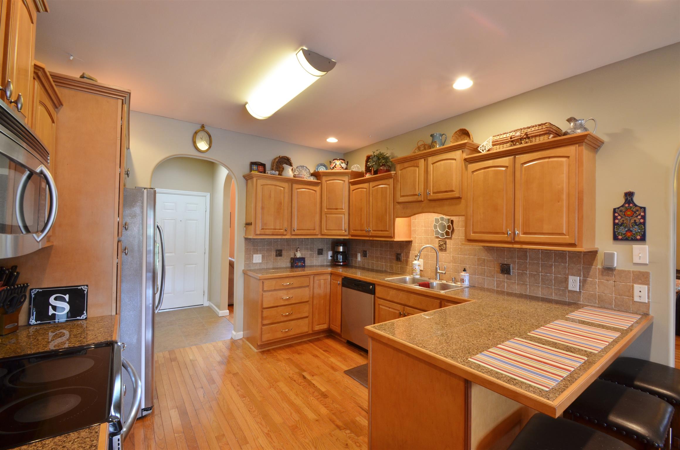 391 Vesta Road Lebanon, TN 37090 - Photo 7 of 24 a kitchen with stainless steel appliances granite countertop a sink refrigerator and cabinets