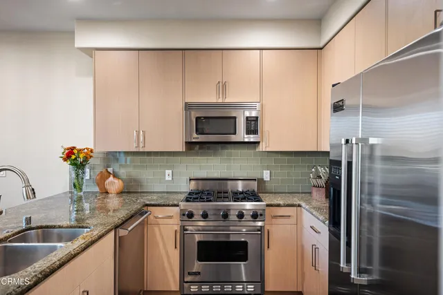 a kitchen with a sink a stove and refrigerator