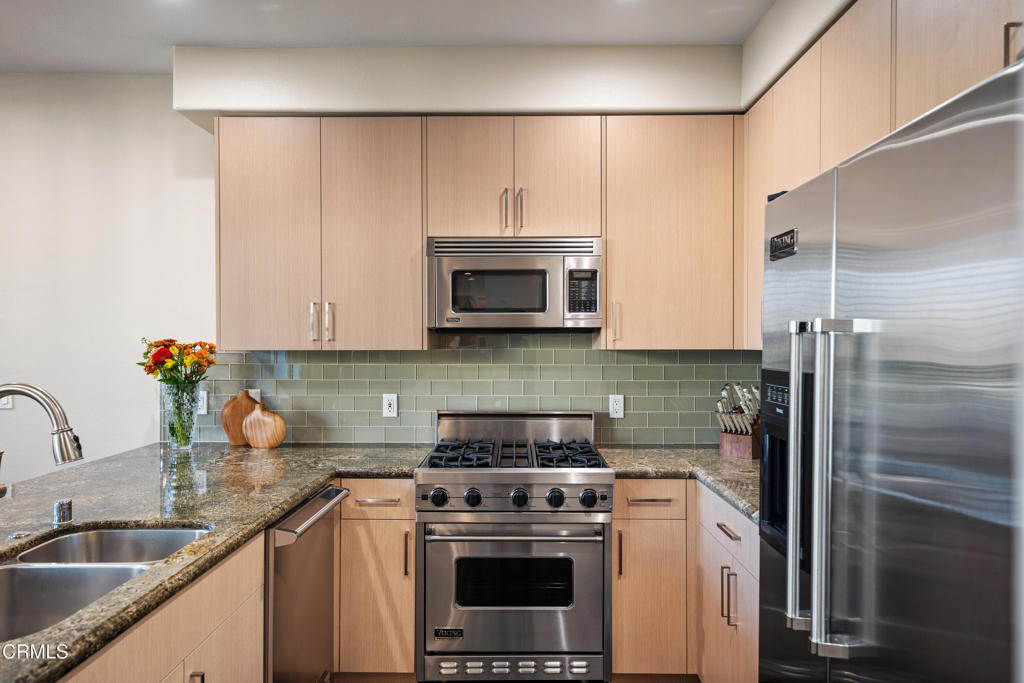 436 Poli Street, Unit 404 Ventura, CA 93001 - Photo 14 of 32 a kitchen with a sink a stove and refrigerator