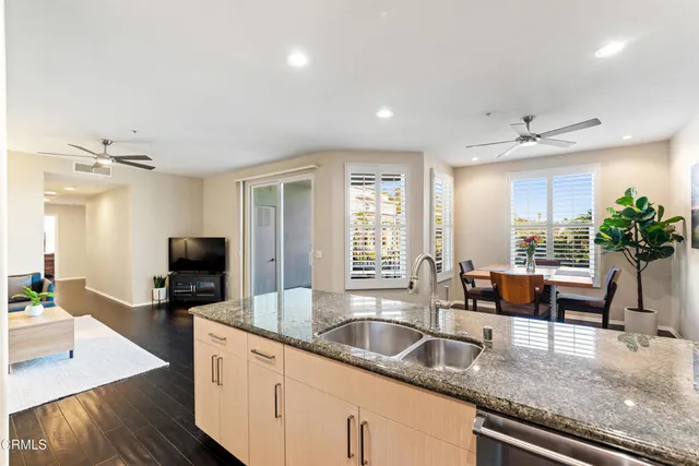 a kitchen with granite countertop a sink and a counter top space