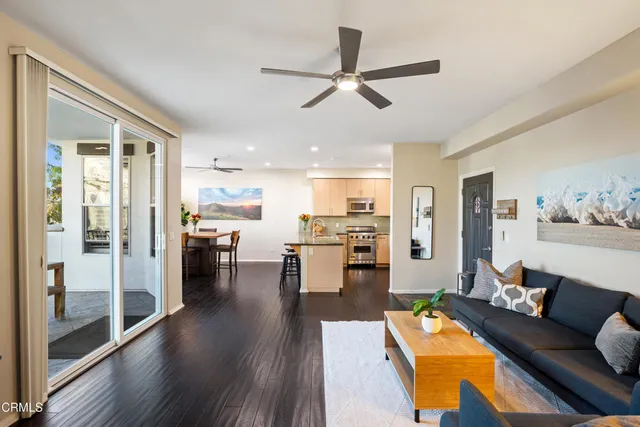 a living room with furniture and kitchen view