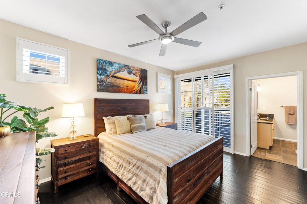 436 Poli Street, Unit 404 Ventura, CA 93001 - Photo 20 of 32 a bedroom with a bed and a chandelier