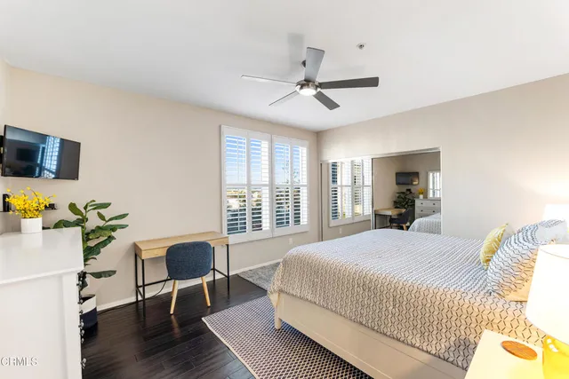 a bedroom with a bed a table and a window