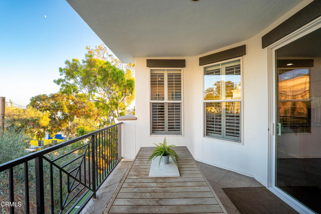 436 Poli Street, Unit 404 Ventura, CA 93001 - Photo 30 of 32 a view of a balcony with wooden floor and fence