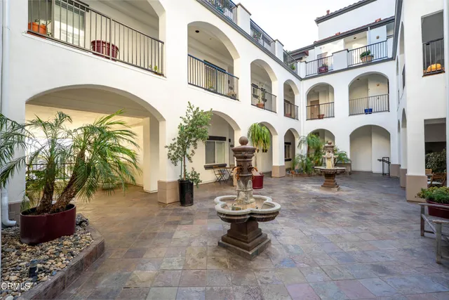a view of a lobby with table and chairs potted plants
