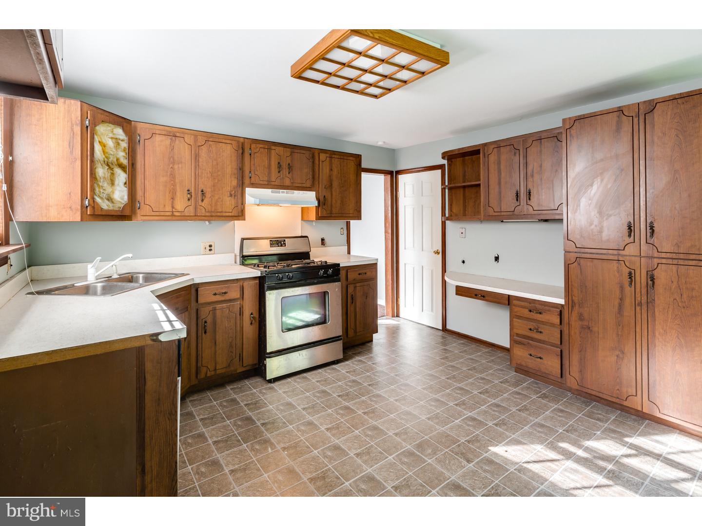 18 Princeton Road Clementon, NJ 08021 - Photo 2 of 19 a kitchen with a stove a sink and a refrigerator
