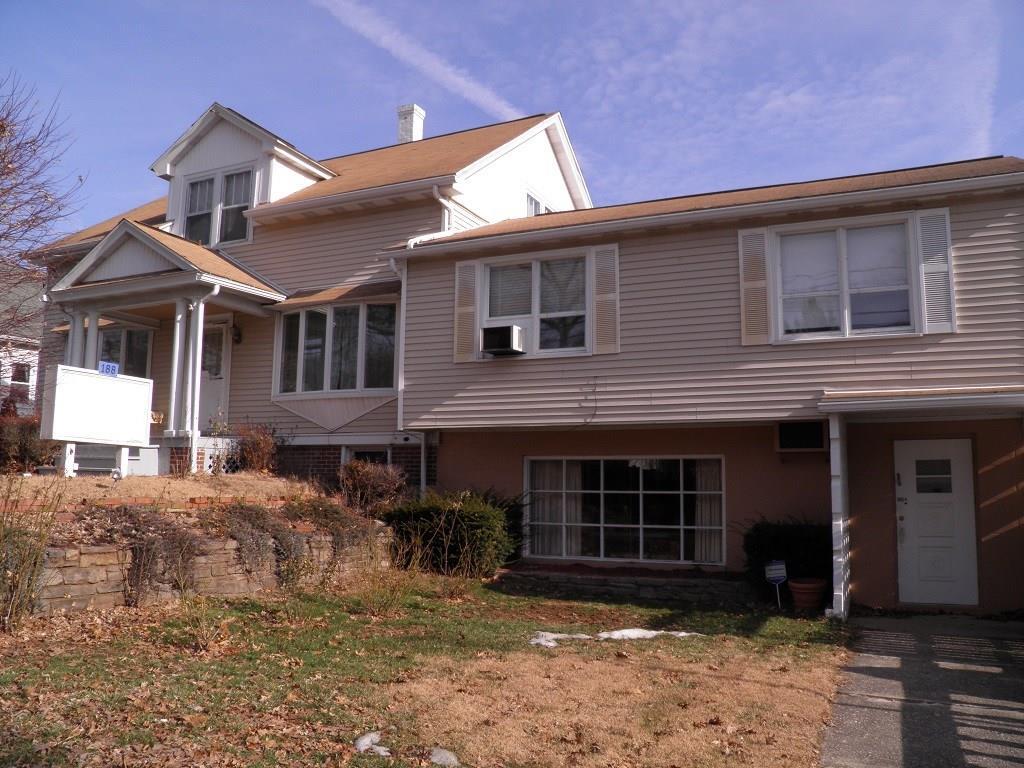 188 Maple Street Killingly, CT 06239 - Photo 1 of 1 a front view of a house with a yard and parking space