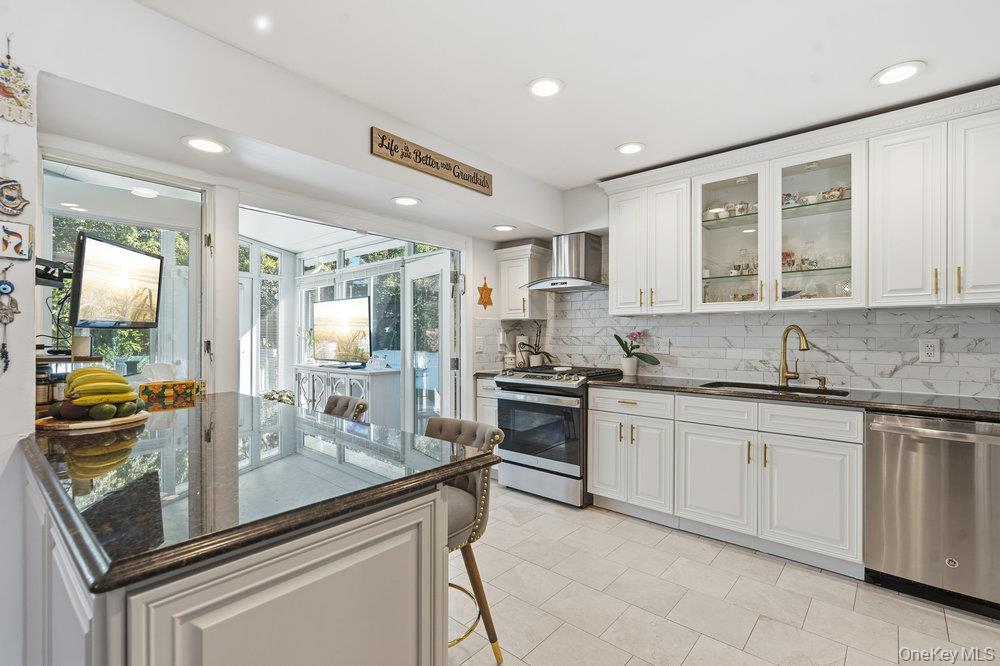 20 Vista Road Plainview, NY 11803 - Photo 12 of 37 a kitchen with stainless steel appliances granite countertop a sink and cabinets