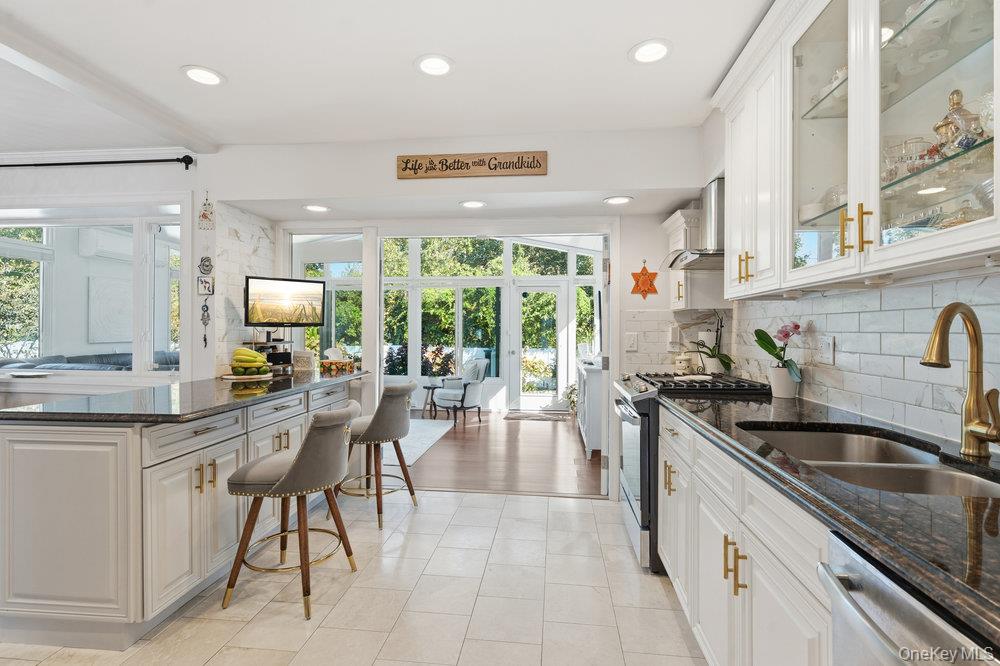 20 Vista Road Plainview, NY 11803 - Photo 15 of 37 a kitchen with stainless steel appliances granite countertop a sink stove and cabinets