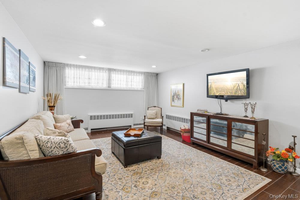 20 Vista Road Plainview, NY 11803 - Photo 23 of 37 a living room with furniture and a flat screen tv