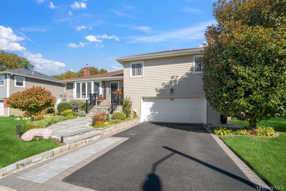 20 Vista Road Plainview, NY 11803 - Photo 3 of 37 a front view of a house with a yard and potted plants