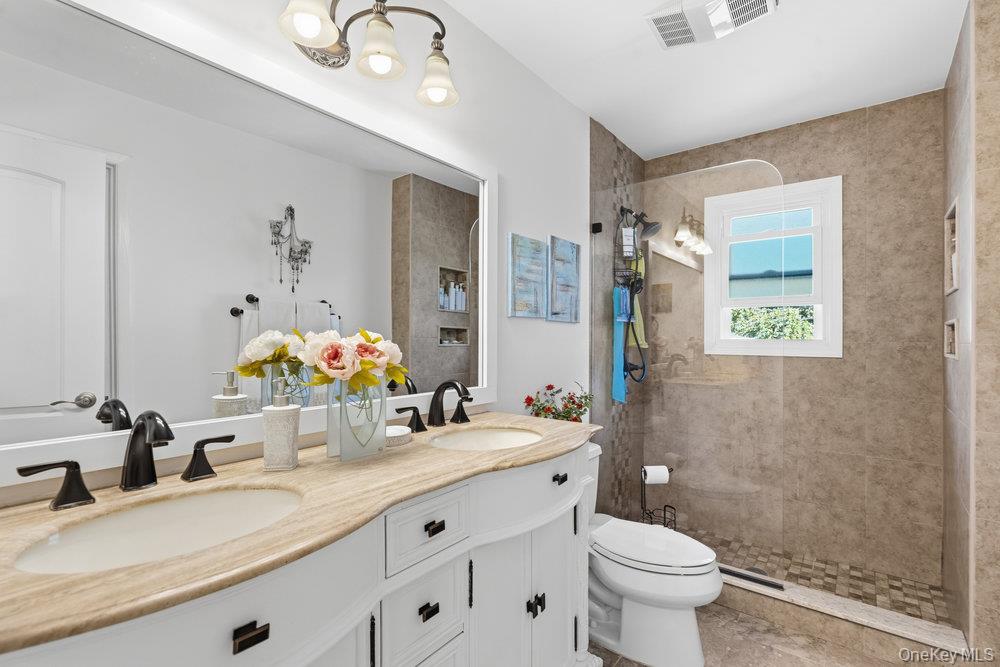 20 Vista Road Plainview, NY 11803 - Photo 31 of 37 a bathroom with a granite countertop sink mirror vanity and toilet