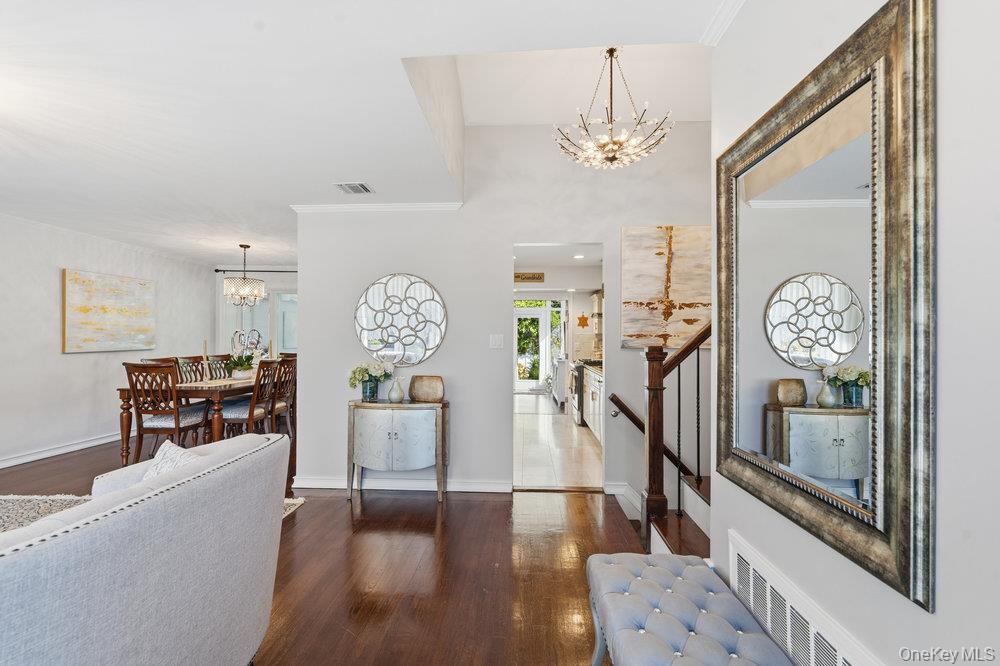 20 Vista Road Plainview, NY 11803 - Photo 5 of 37 a living room with fireplace furniture and a chandelier