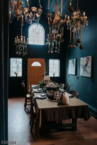 a living room with furniture a chandelier and a wooden floor