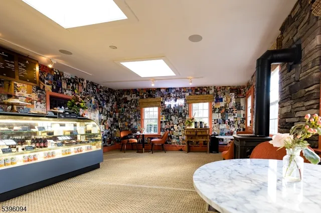 a living room with lots of furniture and a large window