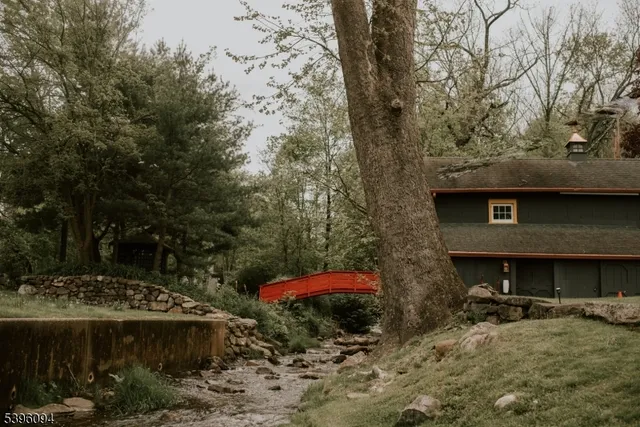 a view of a backyard with a table and chairs under an umbrella