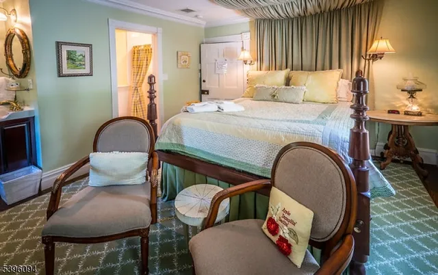 a bedroom with a bed a fireplace and a television