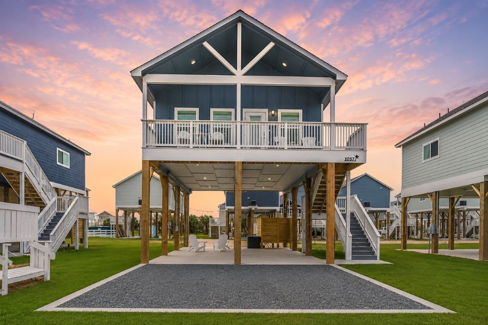 1057 Johnson Road Port Bolivar, TX 77650 - Photo 2 of 40 Your elevated coastal home welcomes you with a spacious covered ground-level area, upper balcony, and plenty of room to enjoy the outdoors.