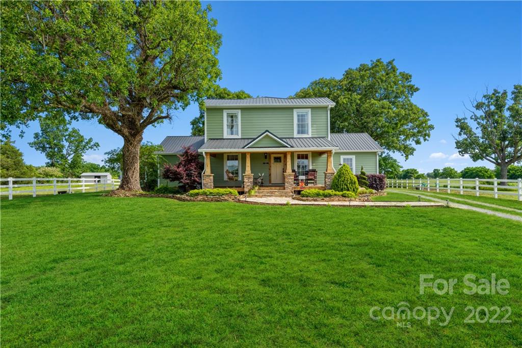 903 Jug Broome Road Monroe, NC 28112 - Photo 1 of 47 a front view of a house with a yard table and chairs