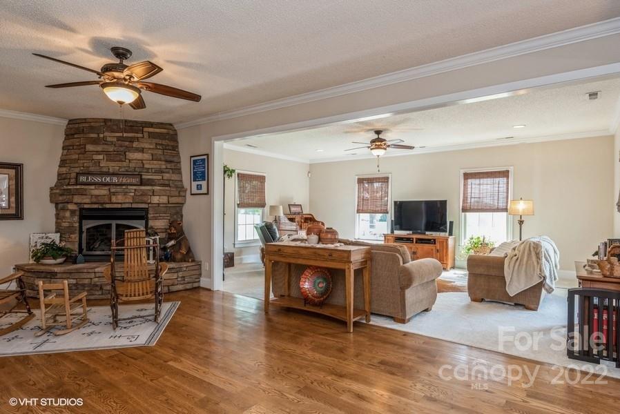 903 Jug Broome Road Monroe, NC 28112 - Photo 17 of 47 a living room with furniture a fireplace and a flat screen tv