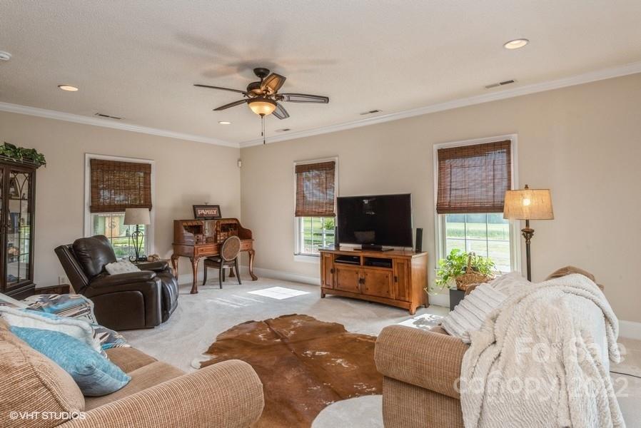903 Jug Broome Road Monroe, NC 28112 - Photo 21 of 47 a living room with furniture a flat screen tv and a large window