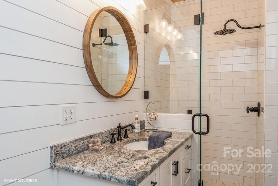 903 Jug Broome Road Monroe, NC 28112 - Photo 25 of 47 a bathroom with a granite countertop sink a mirror and a shower