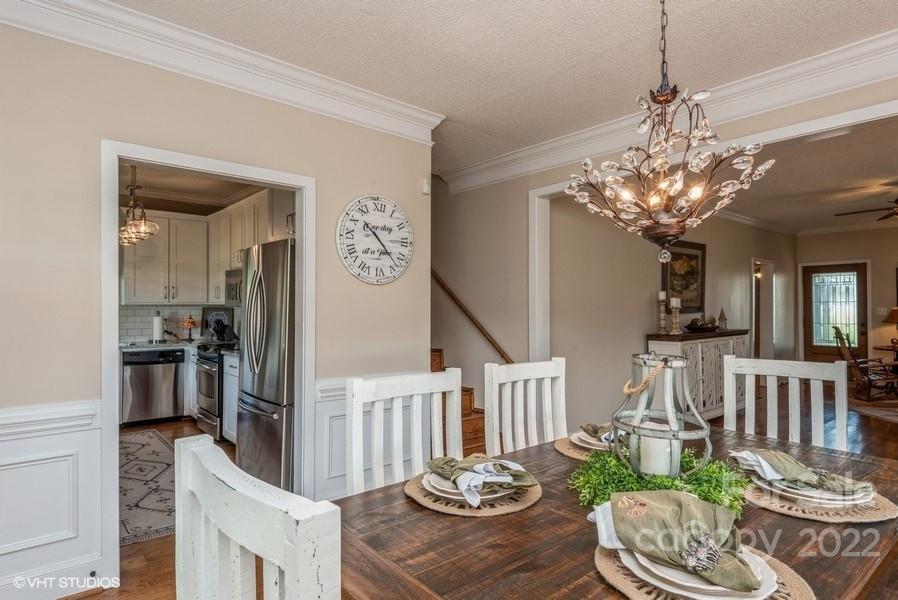 903 Jug Broome Road Monroe, NC 28112 - Photo 10 of 47 a view of a dining room with furniture a chandelier and wooden floor