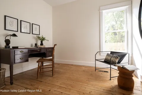 a dining room with furniture and wooden floor