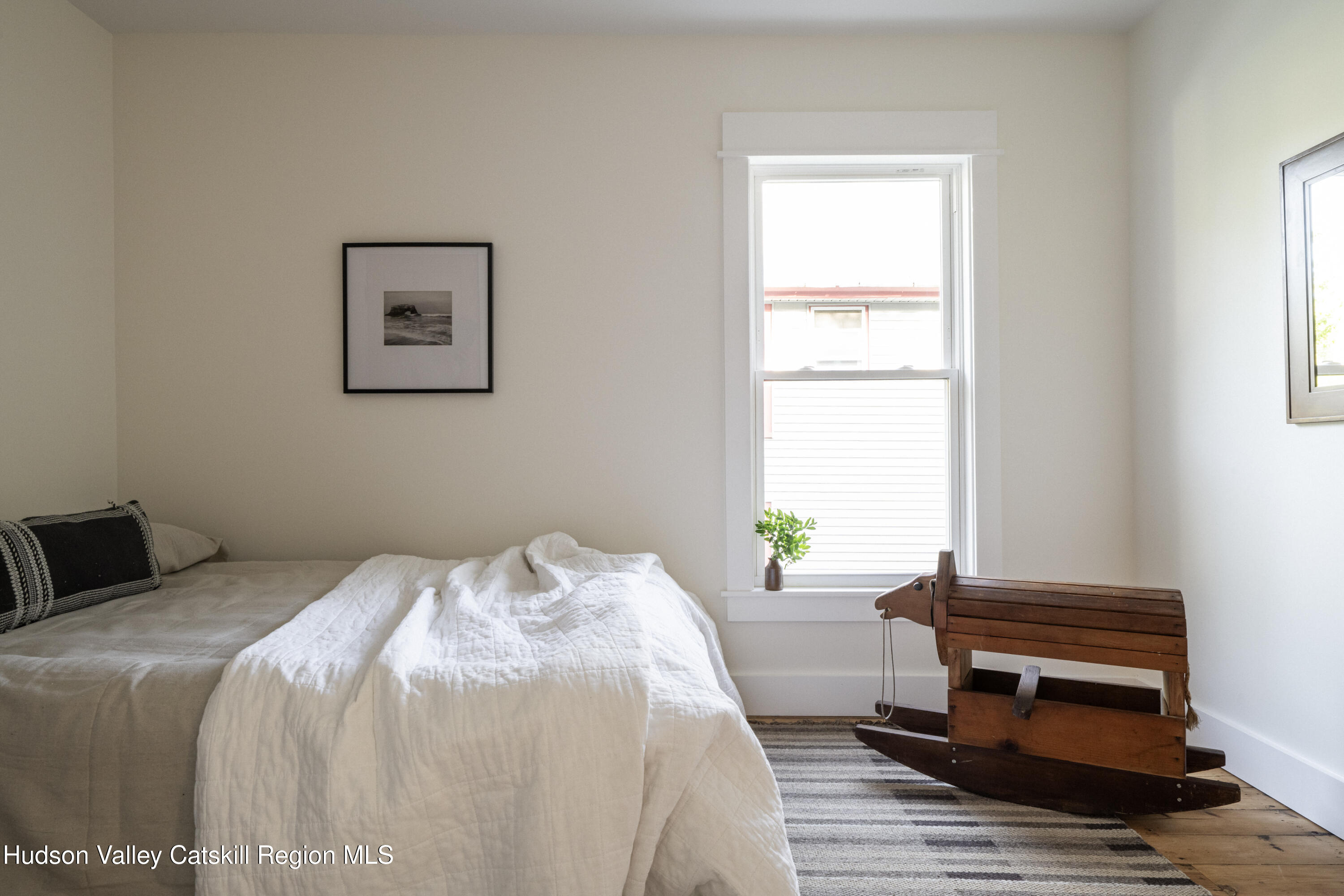 2859 Atlantic Avenue Hudson, NY 12534 - Photo 22 of 32 a bedroom with a bed and a window