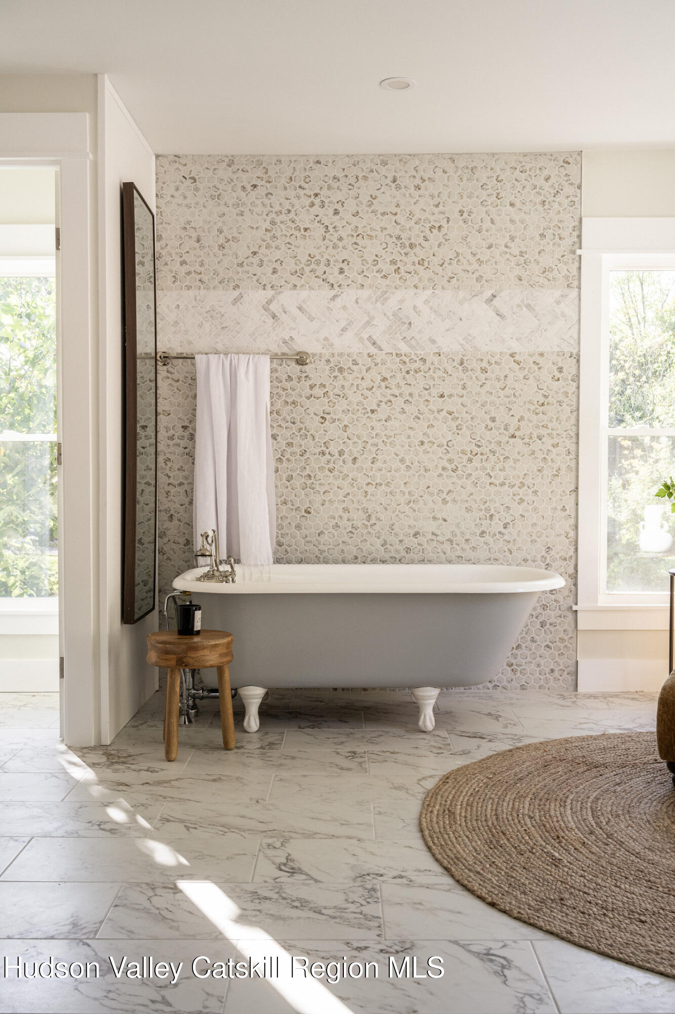 2859 Atlantic Avenue Hudson, NY 12534 - Photo 27 of 32 a bath tub sitting in a room next to a window