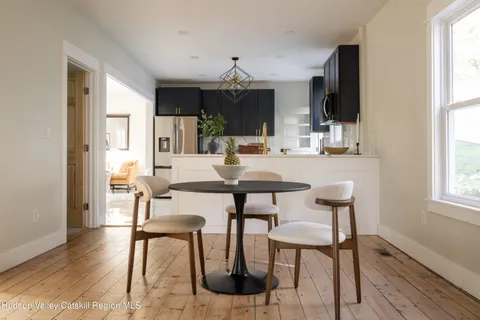 a view of a dining room with furniture and window