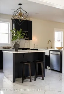 a kitchen with a sink a stove and a wooden cabinets