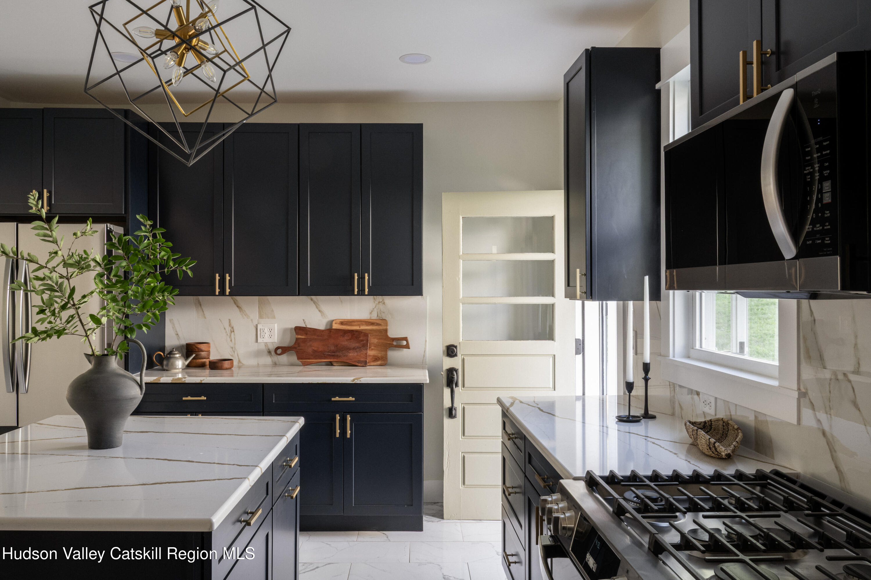 2859 Atlantic Avenue Hudson, NY 12534 - Photo 10 of 32 a kitchen with a sink a stove and a wooden cabinets