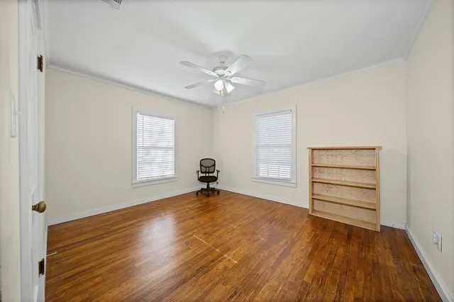 wooden floor in an empty room with a window