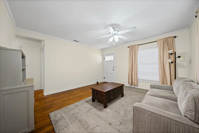 a living room with furniture and a chandelier
