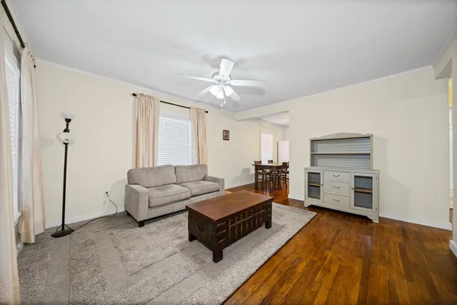 a living room with furniture and a ceiling fan