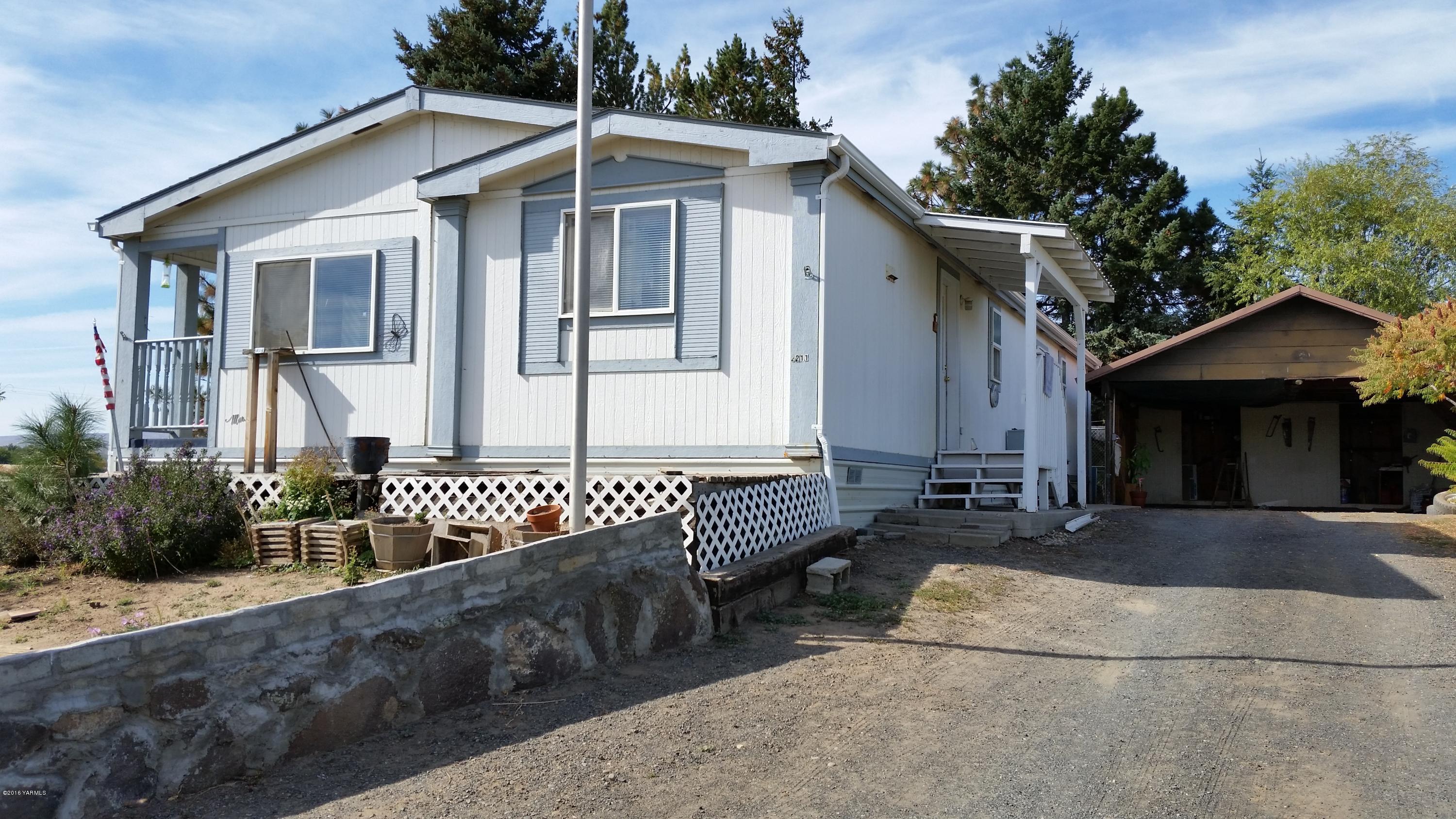 2211 Rosenkranz Road Tieton, WA 98947 - Photo 1 of 29 a front view of a house with garden