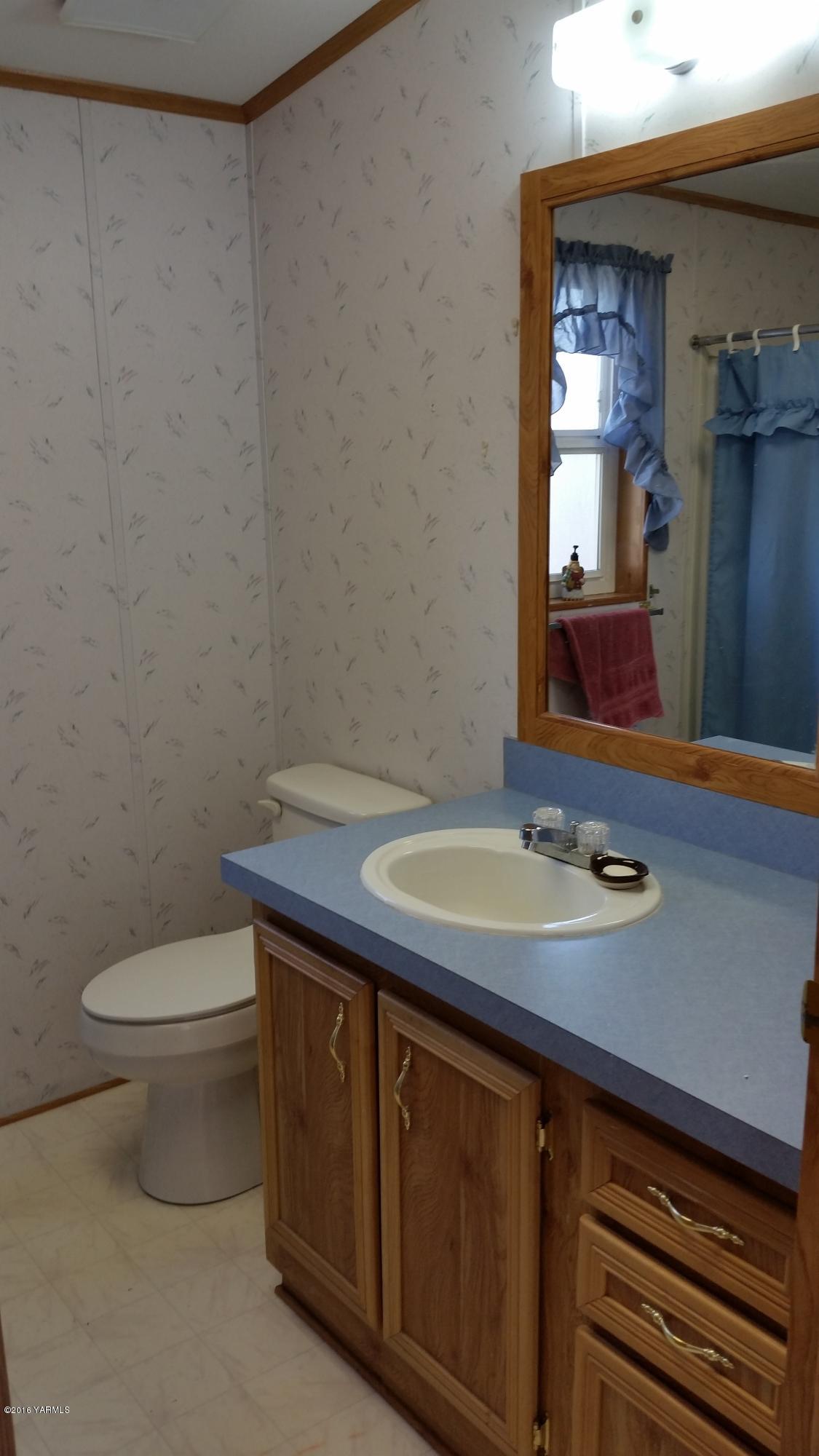 2211 Rosenkranz Road Tieton, WA 98947 - Photo 21 of 29 a bathroom with a sink a toilet and mirror