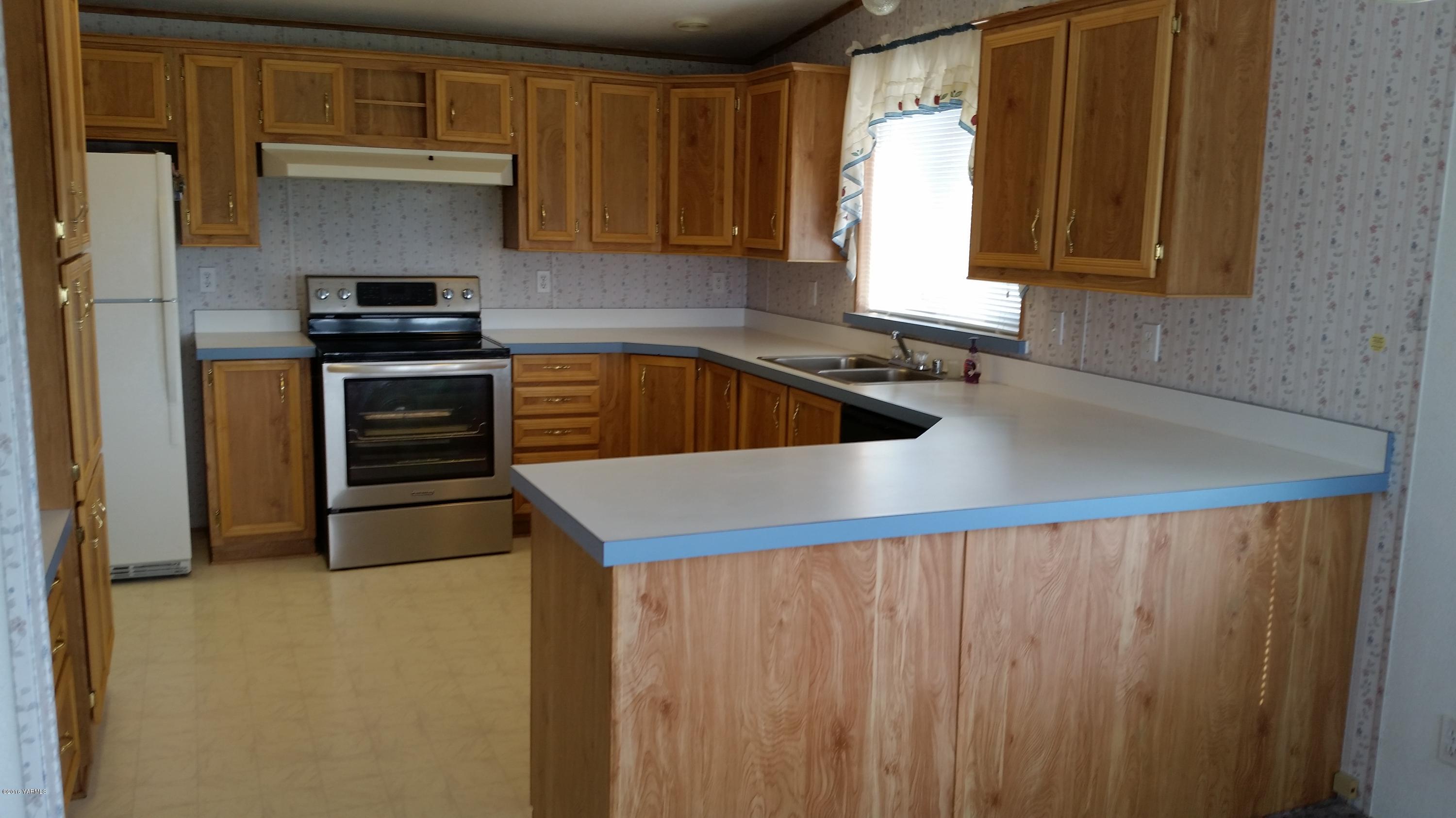 2211 Rosenkranz Road Tieton, WA 98947 - Photo 24 of 29 a kitchen with a sink a stove and a microwave