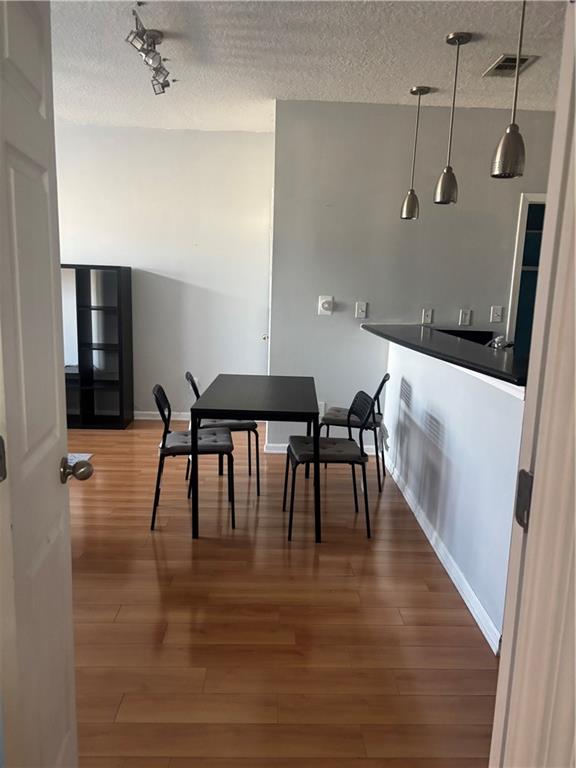 400 17th Street Northwest, Unit 1247 Atlanta, GA 30363 - Photo 1 of 8 a dining room with furniture and wooden floor