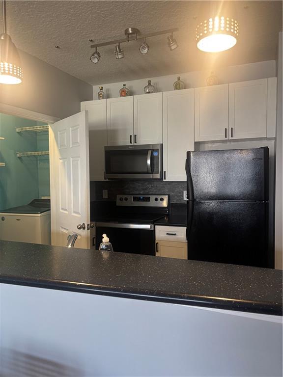 400 17th Street Northwest, Unit 1247 Atlanta, GA 30363 - Photo 2 of 8 a kitchen with kitchen island a counter space a sink and appliances