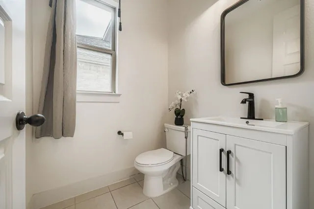 a bathroom with a toilet a sink and mirror